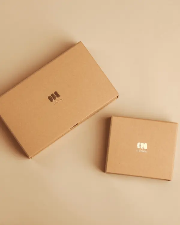 Two kraft-paper boxes on a soft cream surface