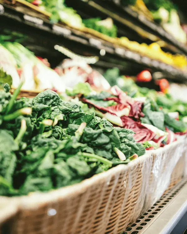 Wicker baskets of unpackaged produce in a small independent grocer