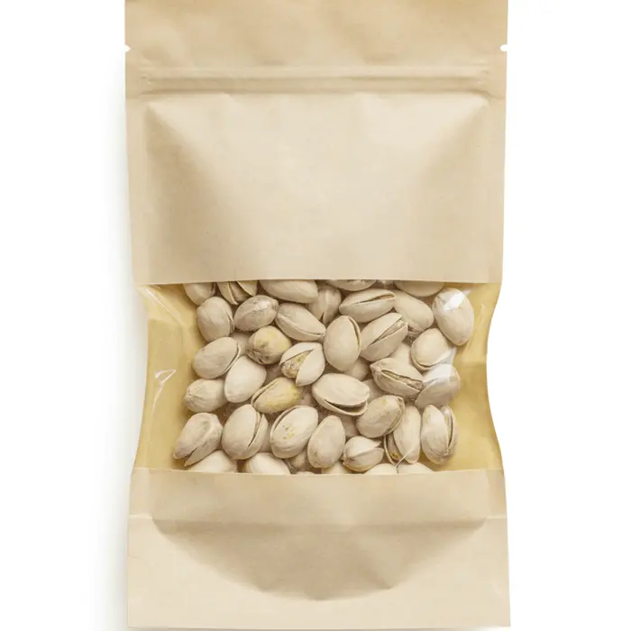 Dried white beans spilling from brown kraft paper packaging